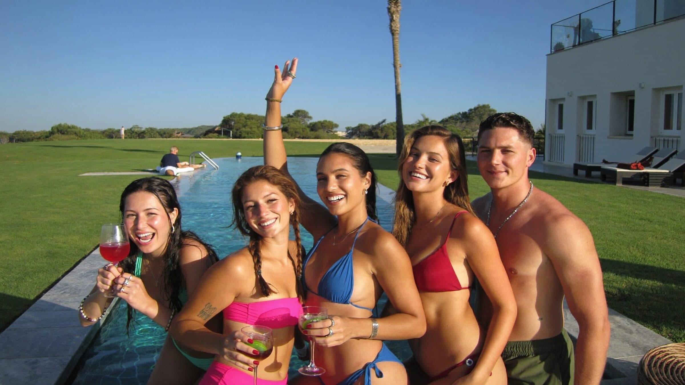 Young creators laughing by a villa pool